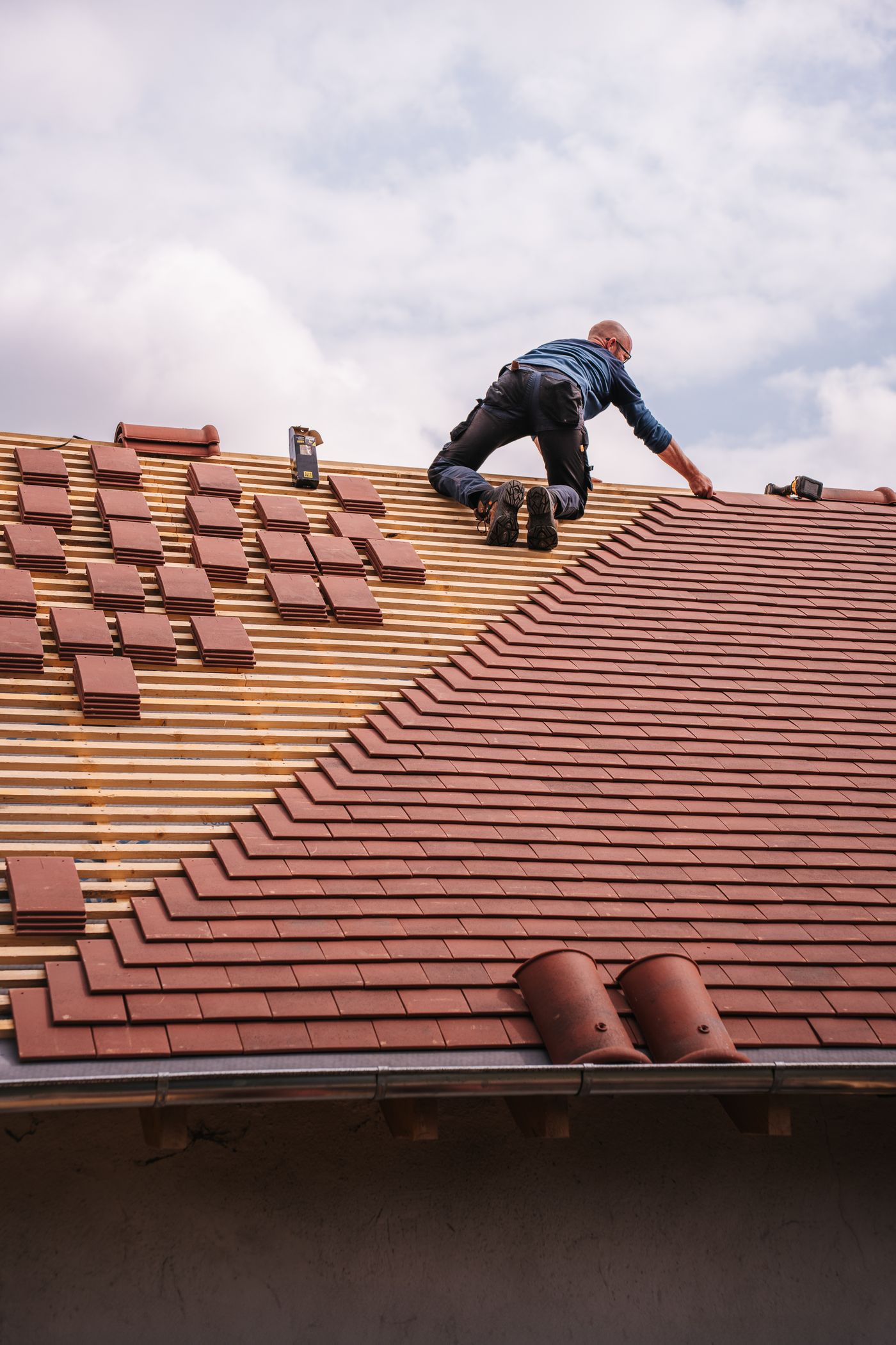 Roofer installing a new roof on a Bronx building